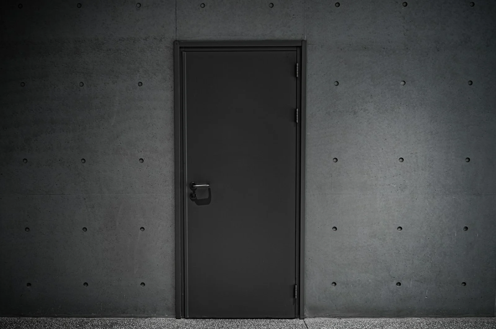 a black door is open in a dark room a black door is open in a dark room