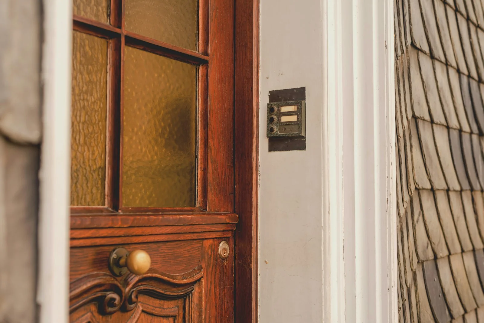 Close-up of a wooden door with a doorbell Close-up of a wooden door with a doorbell